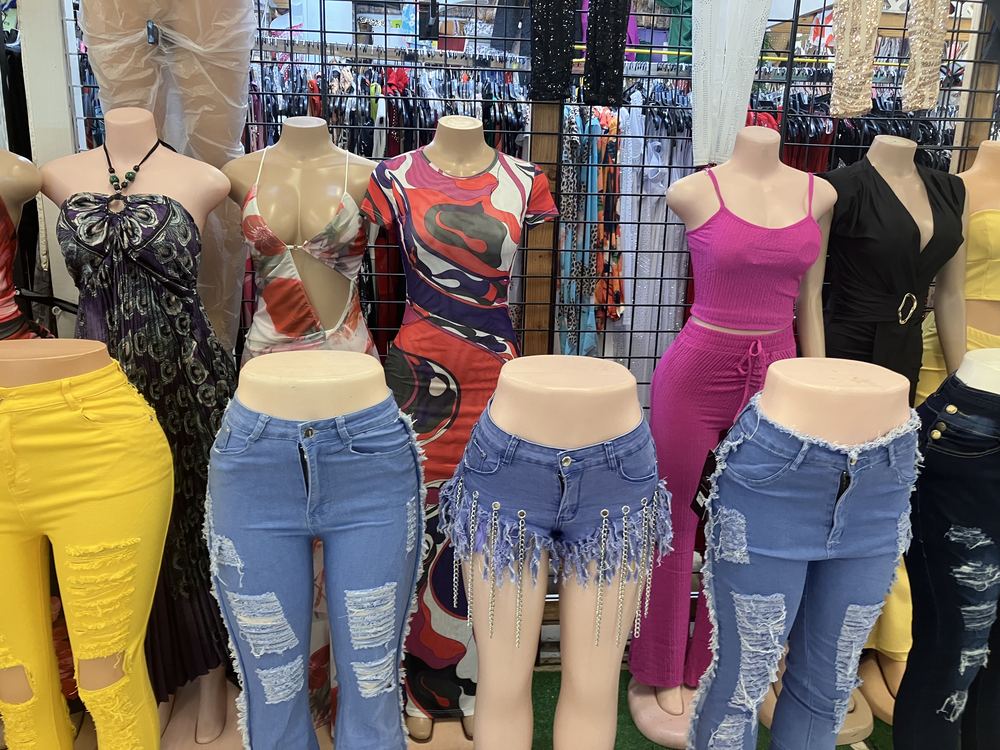 Colorful tops and ripped denim rack