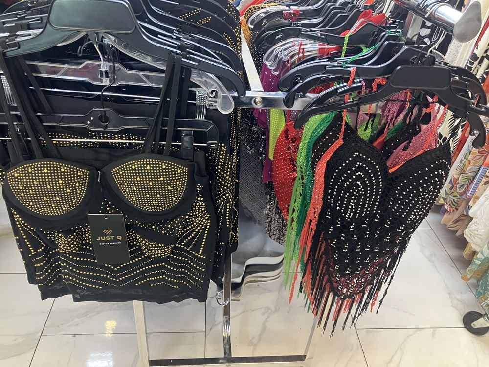 Rhinestone and sequin tops on display rack